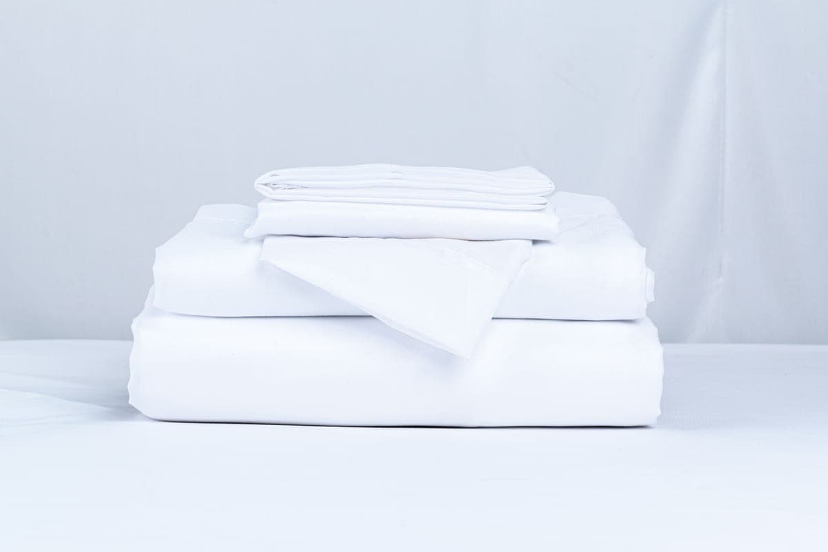 A stack of clean folded bed linen