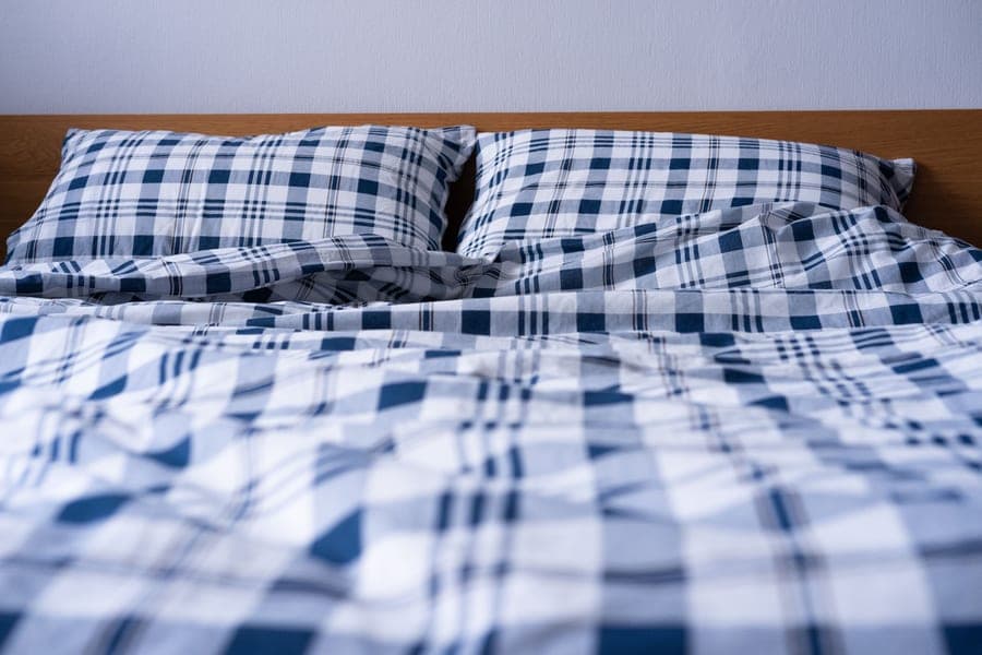 A duvet and comforter on a made bed