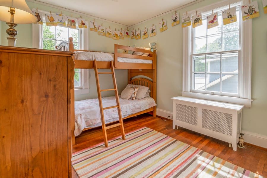 Warm children's bedroom with wooden bunk beds and natural light