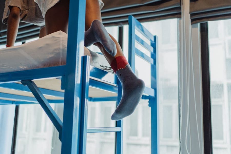 A metal bunk bed frame in a bedroom