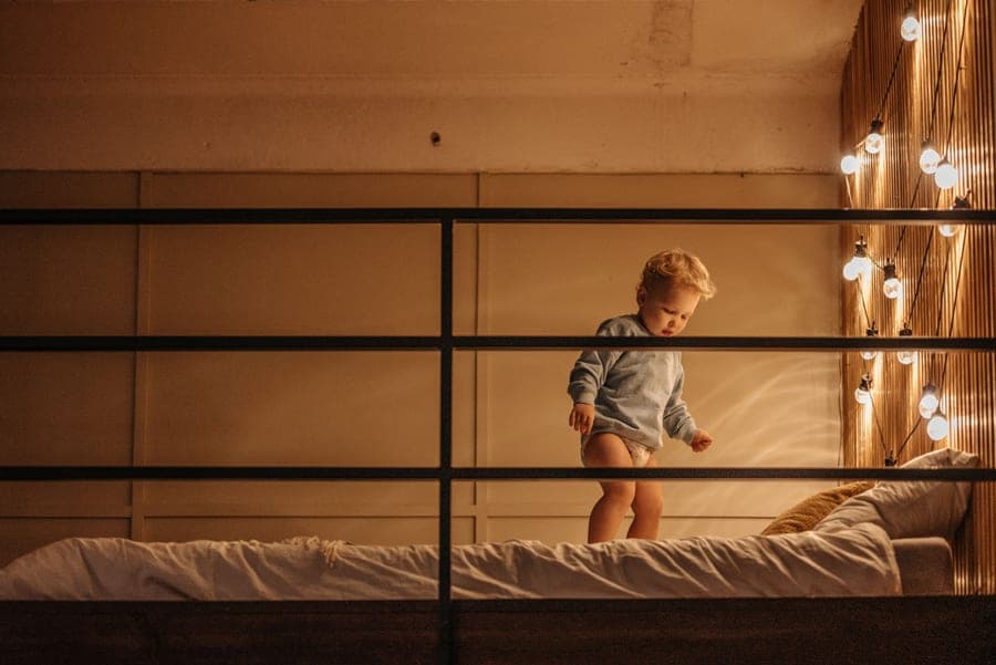 A wooden safety rail on the side of a child's bed
