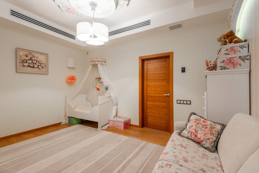 A child's bedroom with pastel-colored furniture